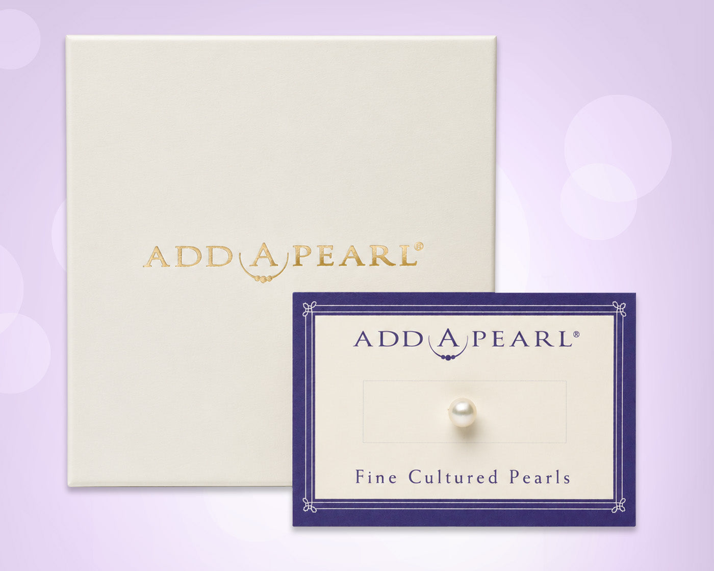 Add A Pearl brand packaging display featuring a cream-colored envelope with gold foil branding and a matching display card showcasing a single round white pearl on a lavender background.