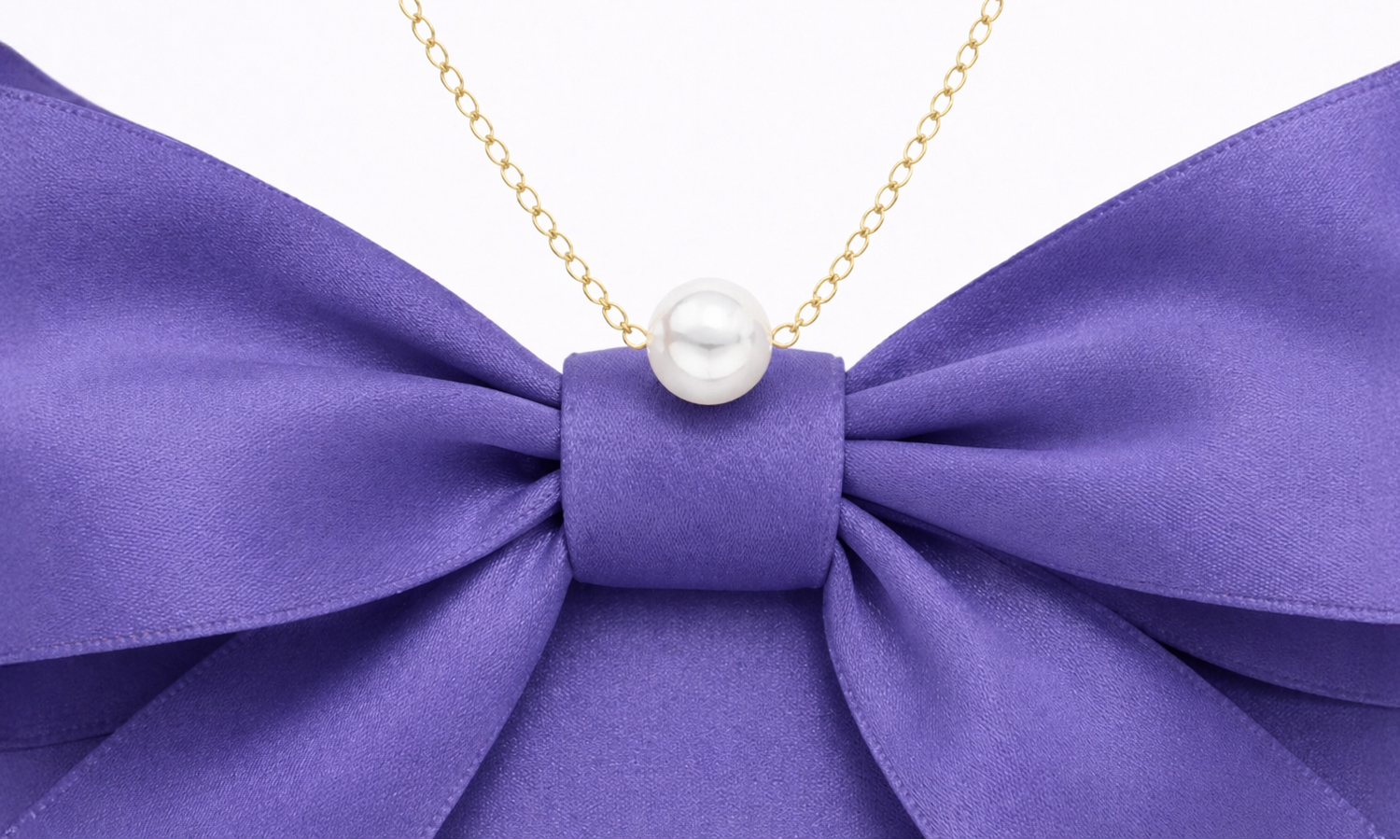Add-A-Pearl pearl necklace on purple bow