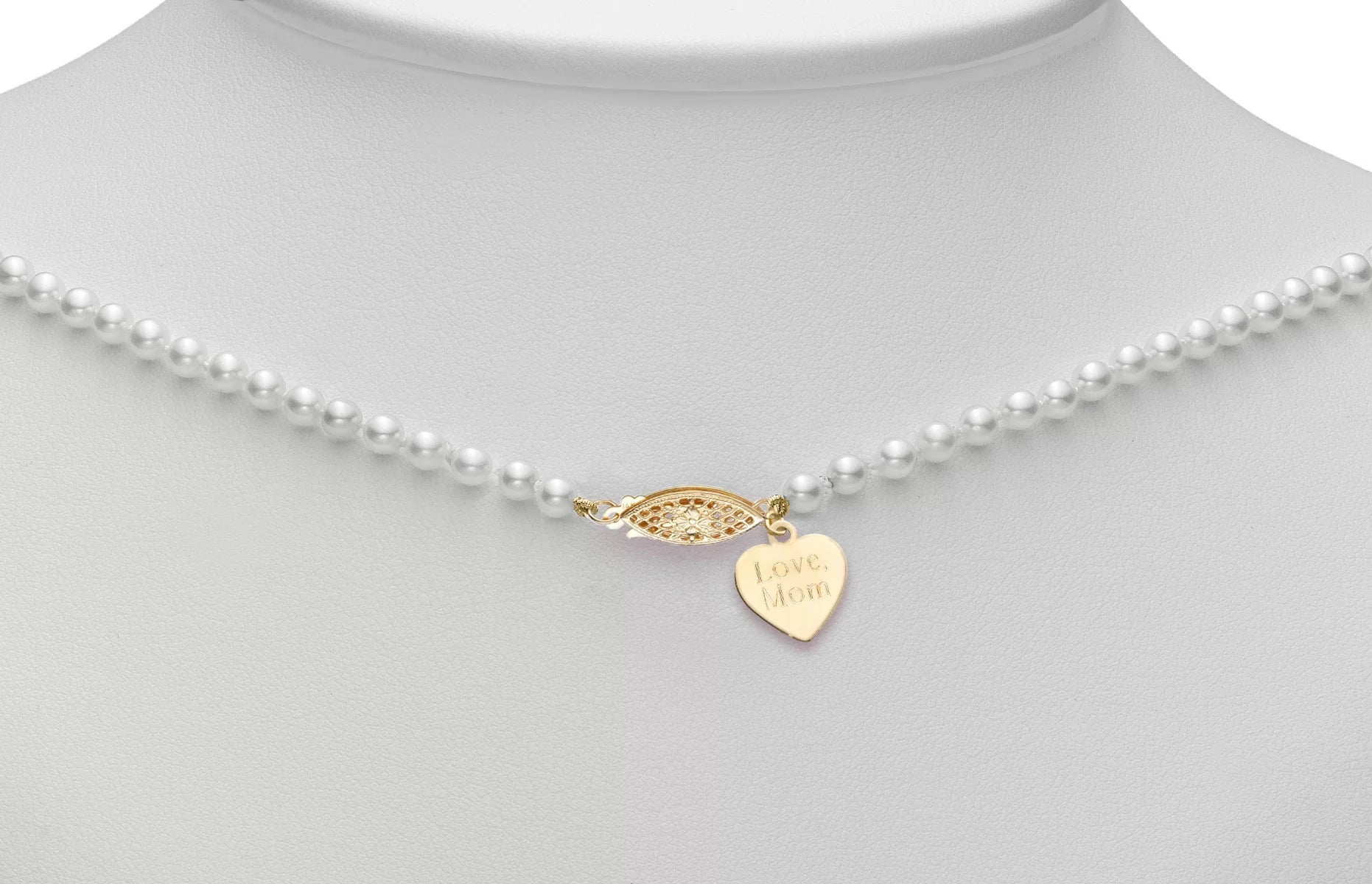 Pearl necklace with a gold heart-shaped pendant and clasp
