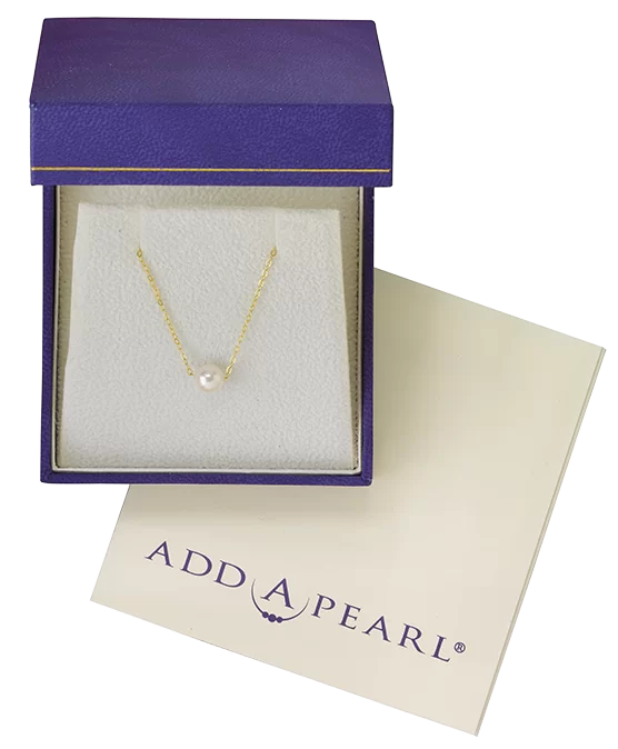 Gold necklace with a single pearl in an elegant purple gift box
