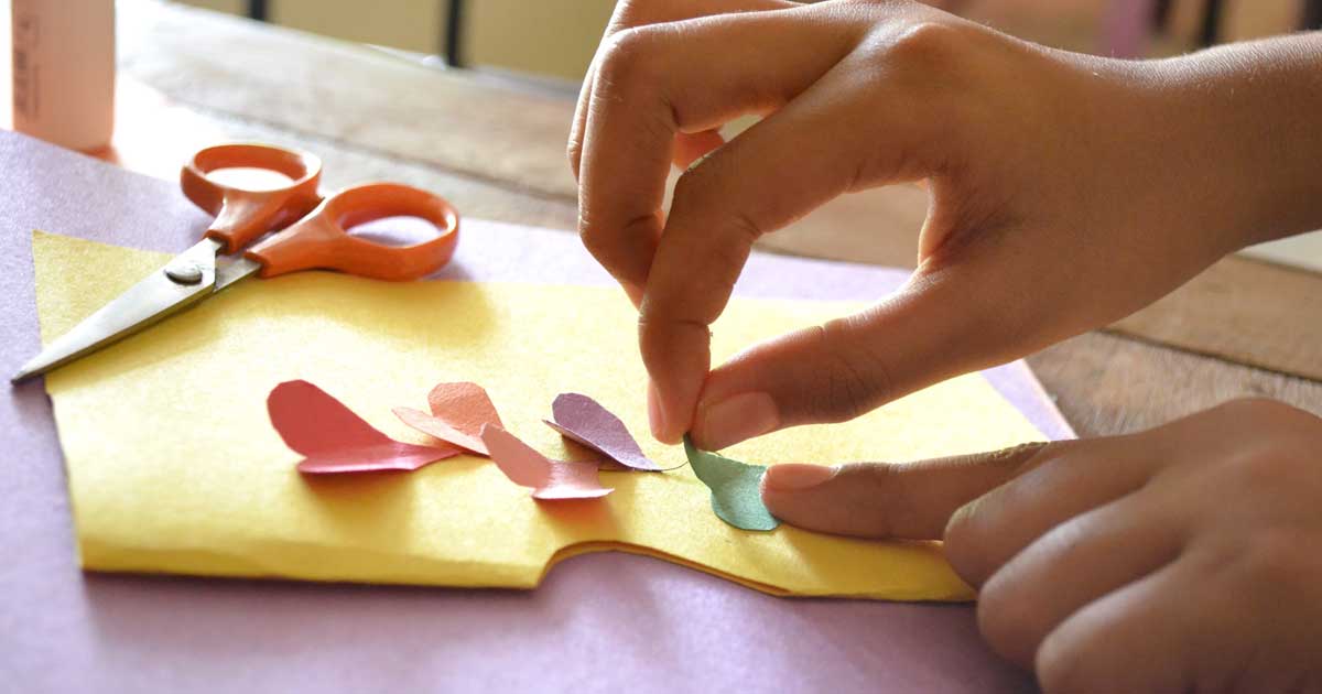 Girl cutting out paper hearts