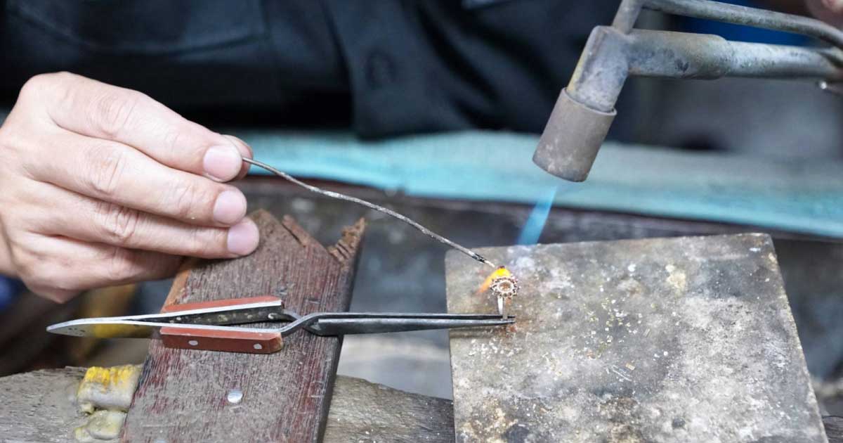 An artisan making a piece of jewelry by hand