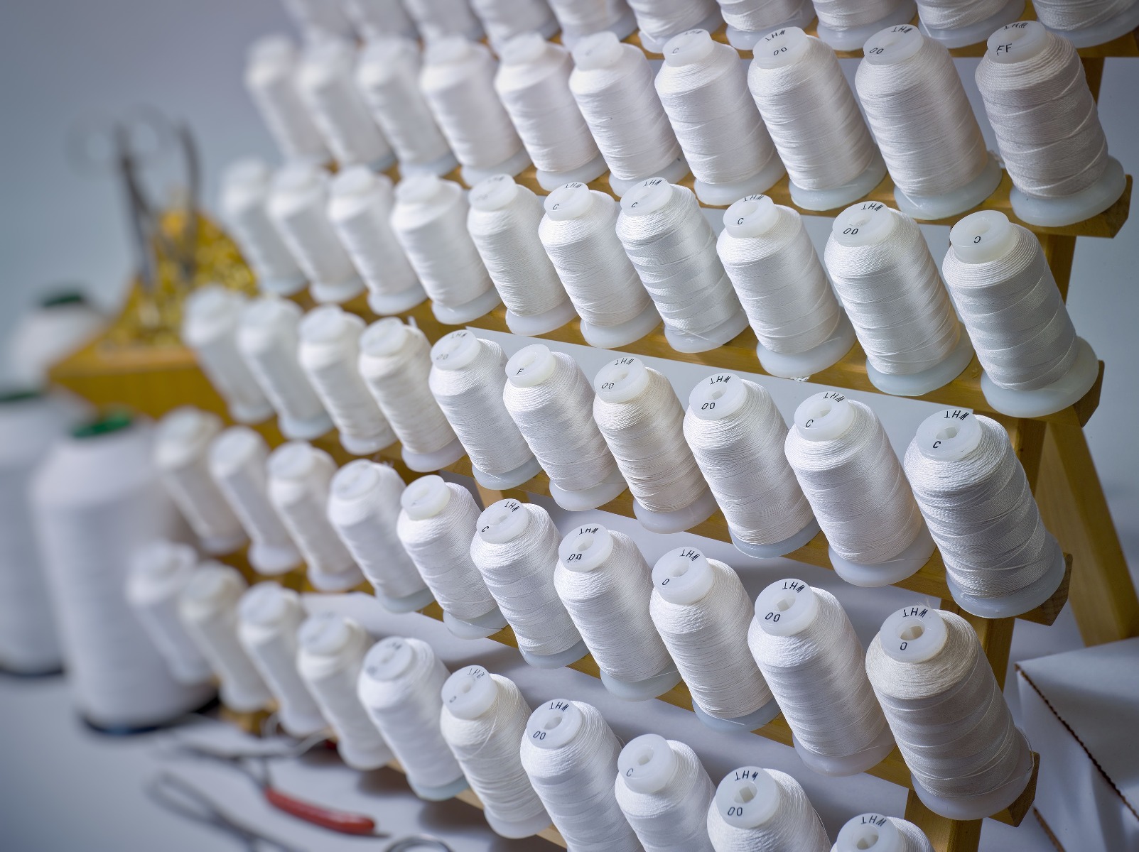 spools of white silk thread for pearl stringing