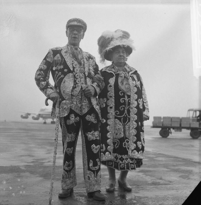King and queen dressed in their garb adorned with pearls.